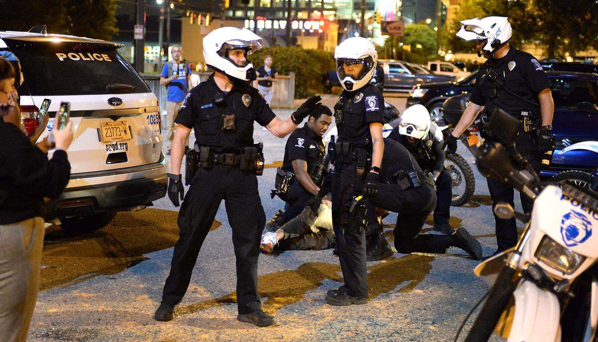 CMPD officers tell protesters to back up as they make an arrest near police headquarters in Charlotte, NC on Sunday, May 31, 2020. Protesters are protesting the death of George Floyd in Minneapolis, MN on Monday, May 25, 2020.