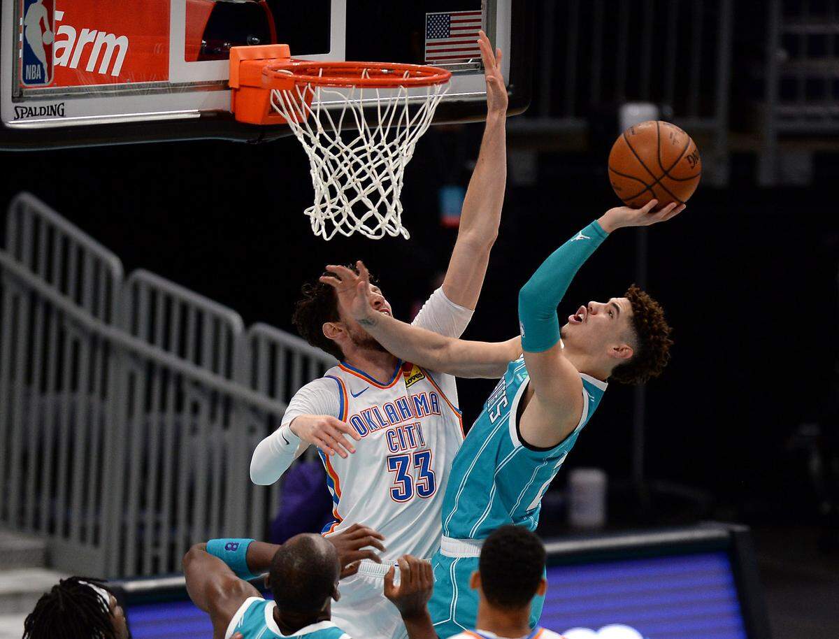 Charlotte Hornets guard LaMelo Ball, right, drives to the basket on Dec. 26th to score against Oklahoma City. Ball often goes left on his drives and uses his left hand to finish, although he’s right-handed.