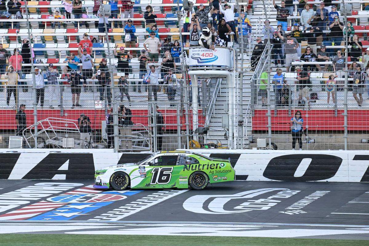 AJ Allmendinger (16) takes the checkered flag to win the NASCAR Xfinity auto race at Charlotte Motor Speedway on Saturday, Oct. 8, 2022, in Concord, N.C. (AP Photo/Matt Kelley)