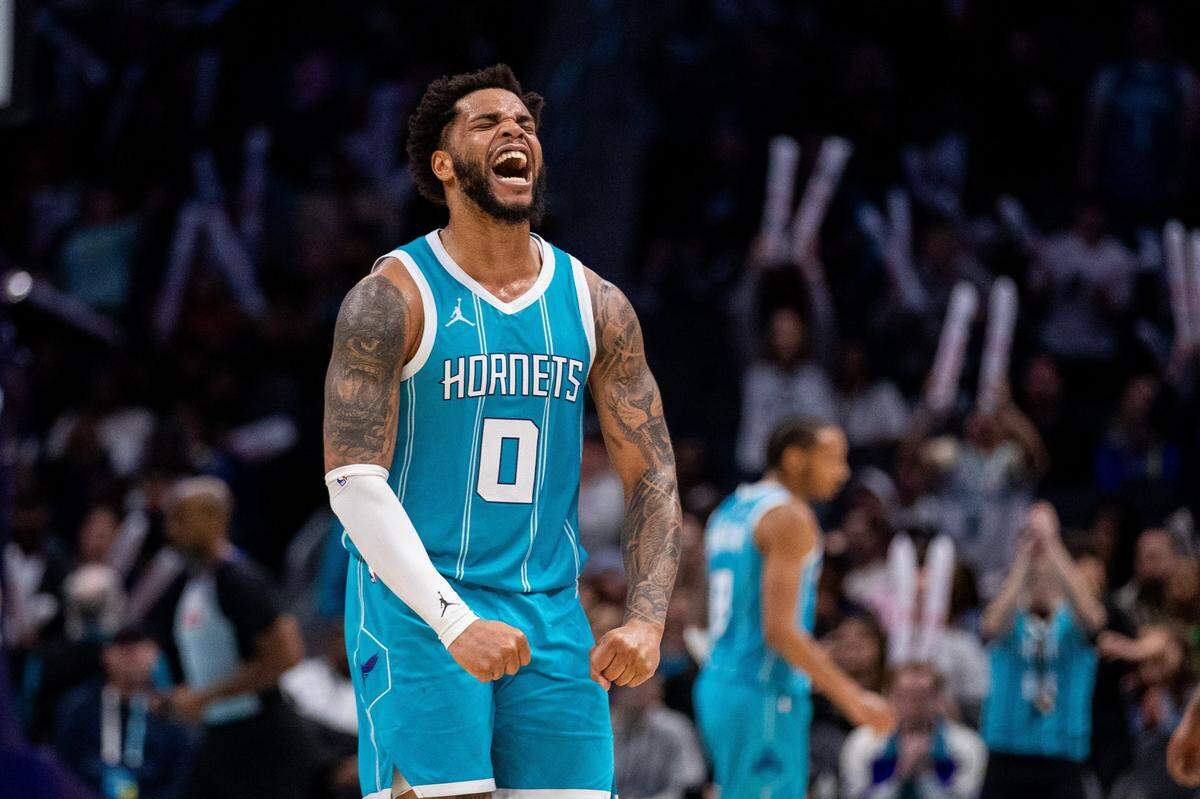 Mar 8, 2025; Charlotte, North Carolina, USA; Charlotte Hornets forward Miles Bridges (0) celebrates after taking the lead against the Brooklyn Nets during the fourth quarter at Spectrum Center. Mandatory Credit: Scott Kinser-Imagn Images