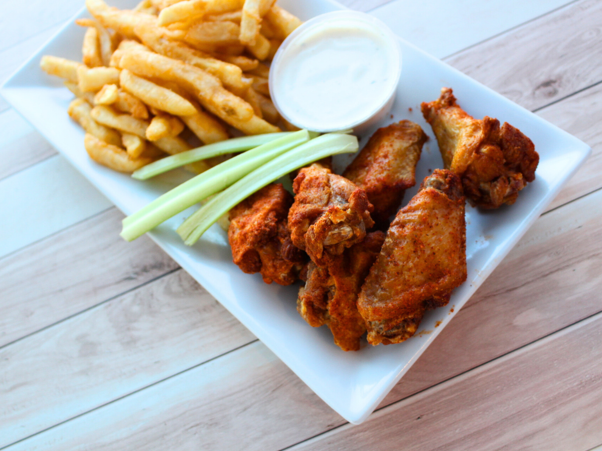 Empire Pizza’s offerings include wings and fries.
