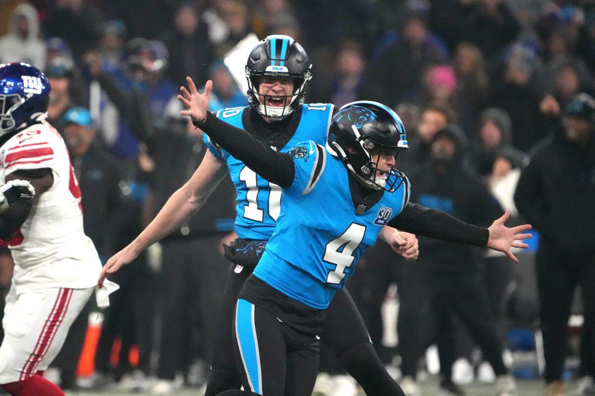 Nov 10, 2024; Munich, Germany; Carolina Panthers place kicker Eddy Pineiro (4) celebrates with punter Johnny Hekker (10) after kicking a 36-yard field goal in overtime against the New York Giants during the 2024 NFL Munich Game at Allianz Arena. Mandatory Credit: Kirby Lee-Imagn Images