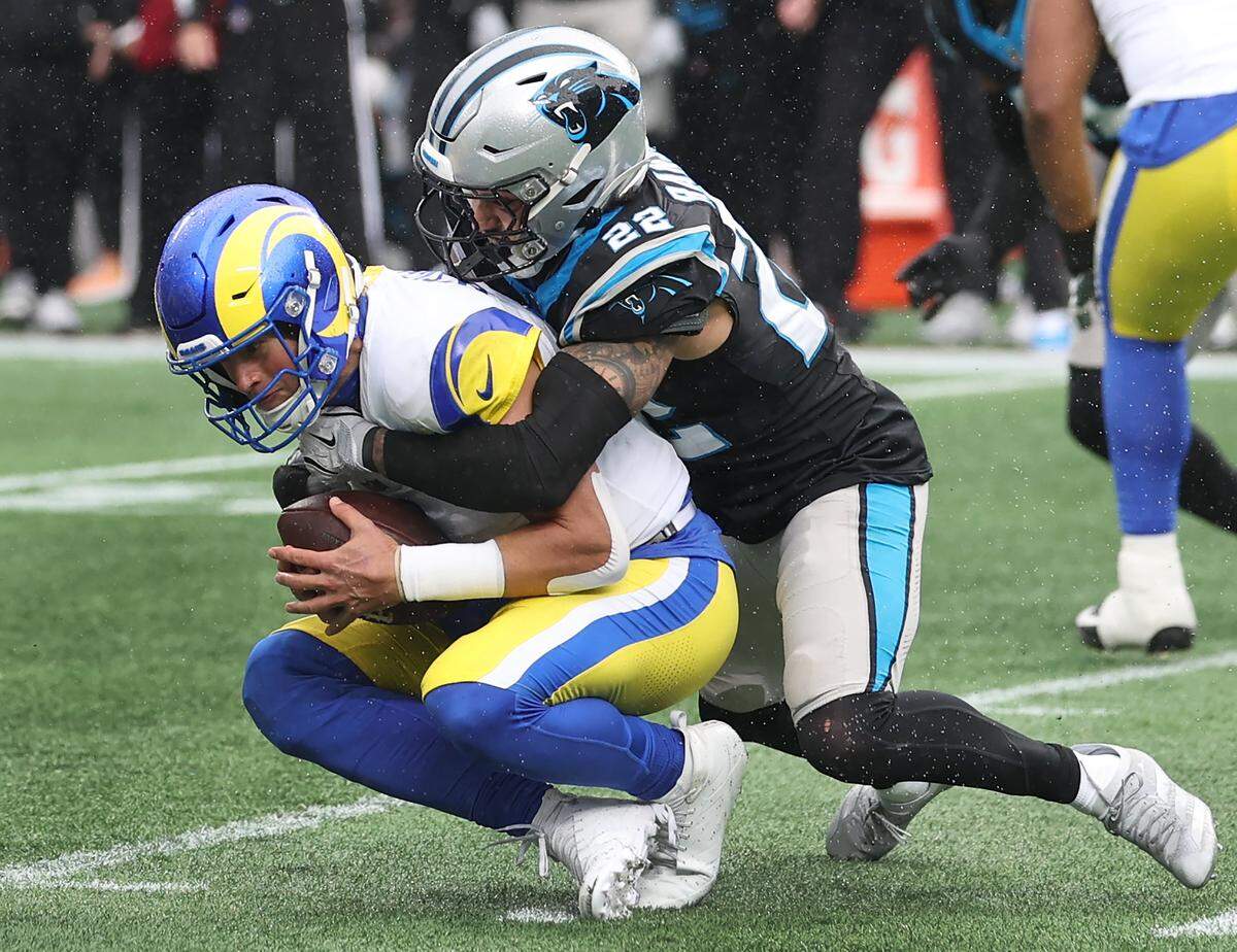 Carolina Panthers safety Lathan Ransom, right, sacks Los Angeles Rams quarterback Matthew Stafford, left, during action at Bank of America Stadium in Charlotte, NC on Sunday, November 30, 2025. The Panthers defeated the Rams 31-28.