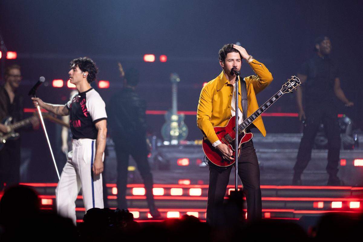 Nick Jonas runs his hands through his hair as The Jonas Brothers perform at the Spectrum Center in Charlotte, North Carolina on September 30, 2023.