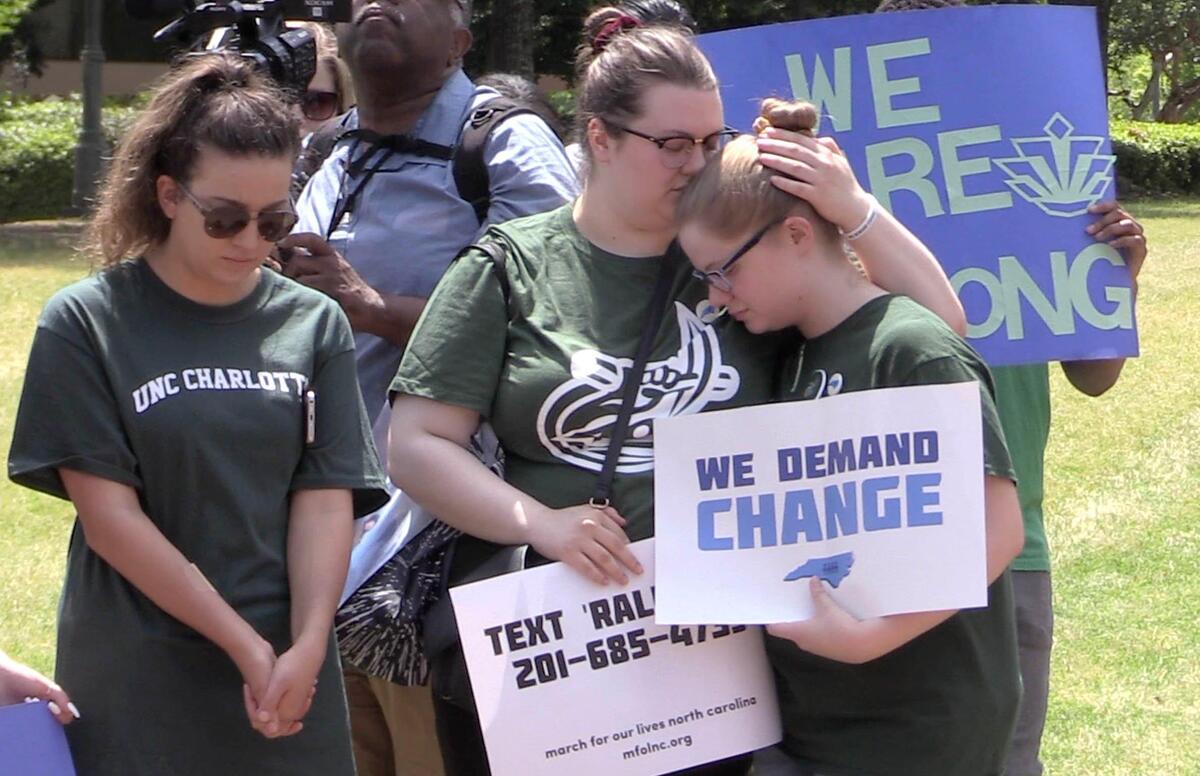 Participants at the Rally of Remembrance pause for a moment of silence on the campus of UNC Charlotte on Friday, May 3, 2019, in the aftermath of the deadly classroom shooting on campus on Tuesday.