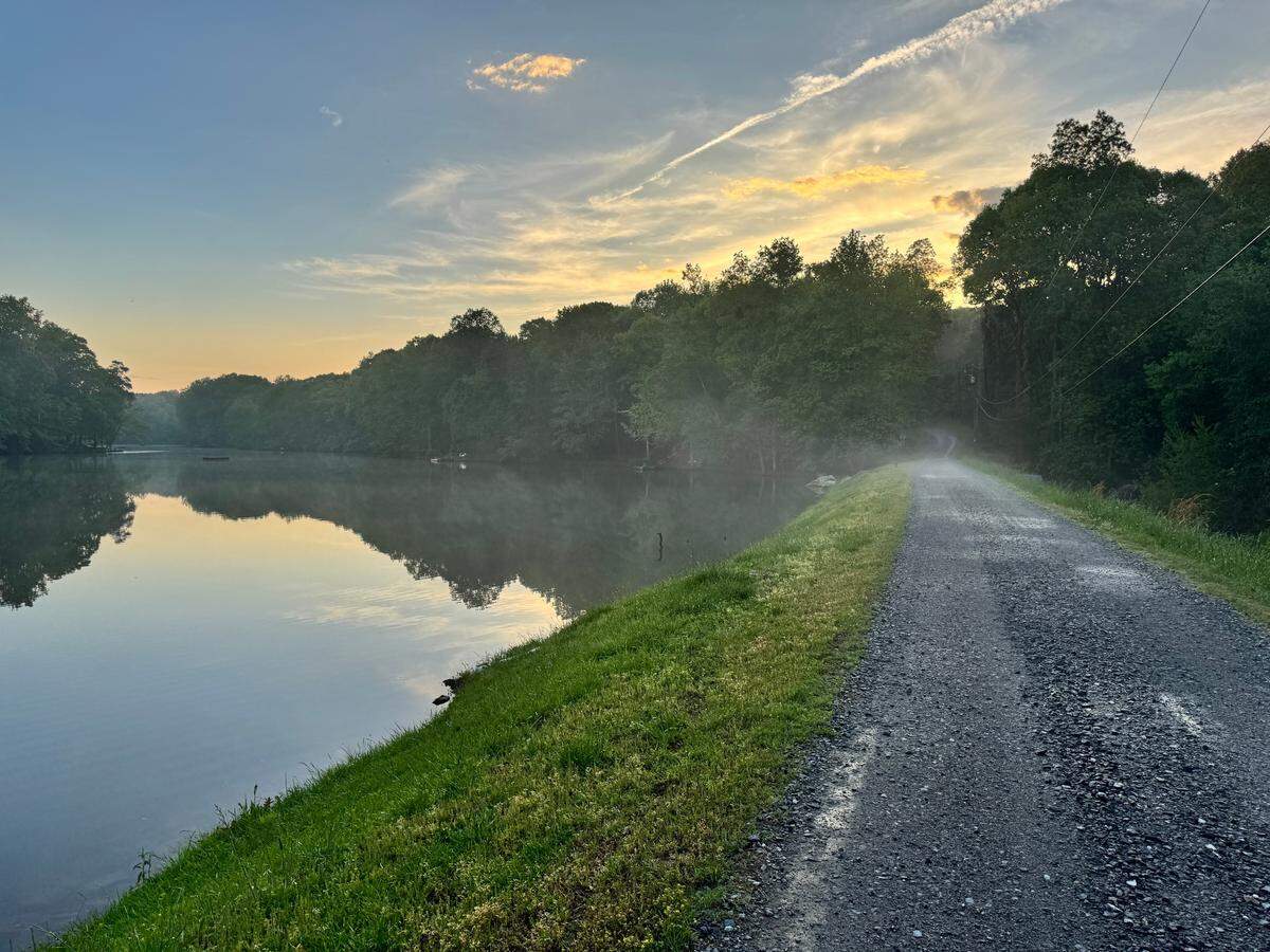 A neighborhood lake in Charlotte, NC, is surrounded by homes and walking trails.
