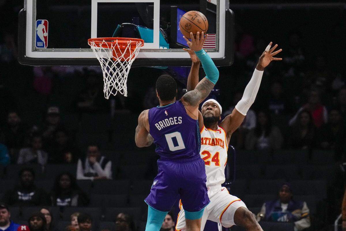 Charlotte Hornets forward Miles Bridges (0) goes up for a basket defended by Atlanta Hawks forward Bruno Fernando (24) during the first quarter at Spectrum Center.