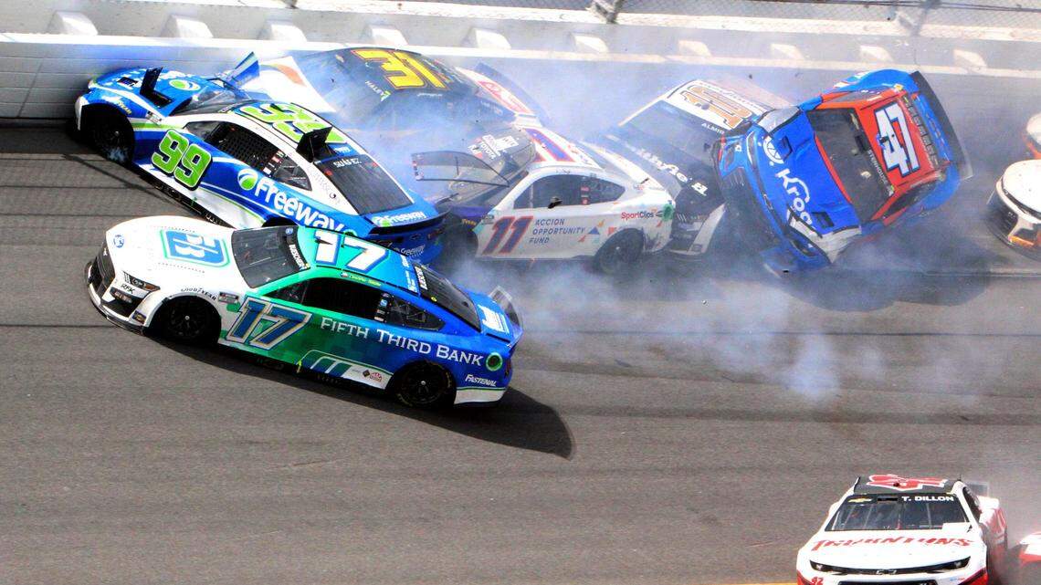 Chris Buescher (17), Daniel Suarez (99), Denny Hamlin (11), Justin Haley (31), Ty Dillon (42), Aric Almirola (10) and Ricky Stenhouse Jr. (47) are involved in a multi-car accident between turns 1 and 2 on Lap 138 of the NASCAR Cup Series race at Daytona International Speedway, Sunday, Aug. 28, 2022, in Daytona Beach, Fla. (AP Photo/Dow Graham)