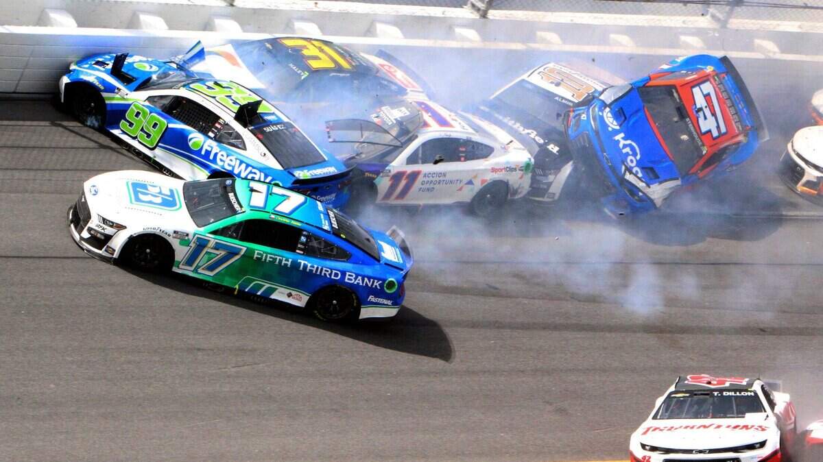 Chris Buescher (17), Daniel Suarez (99), Denny Hamlin (11), Justin Haley (31), Ty Dillon (42), Aric Almirola (10) and Ricky Stenhouse Jr. (47) are involved in a multi-car accident between turns 1 and 2 on Lap 138 of the NASCAR Cup Series race at Daytona International Speedway, Sunday, Aug. 28, 2022, in Daytona Beach, Fla. (AP Photo/Dow Graham)