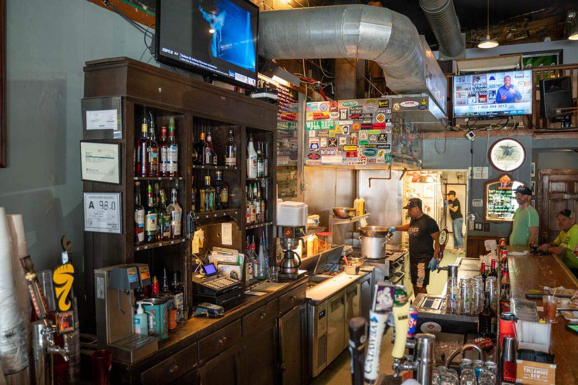 Guests watch as their food is made right next to the bar at Comet Grill.