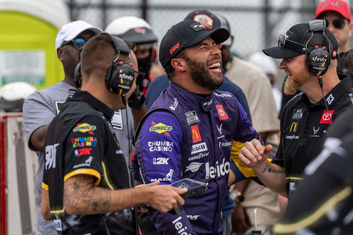 Apr 26, 2025; Talladega, Alabama, USA; NASCAR Cup Series driver Bubba Wallace (23) shares a lighter moment with his team after his run during Jack Link’s 500 qualifying at Talladega Superspeedway.