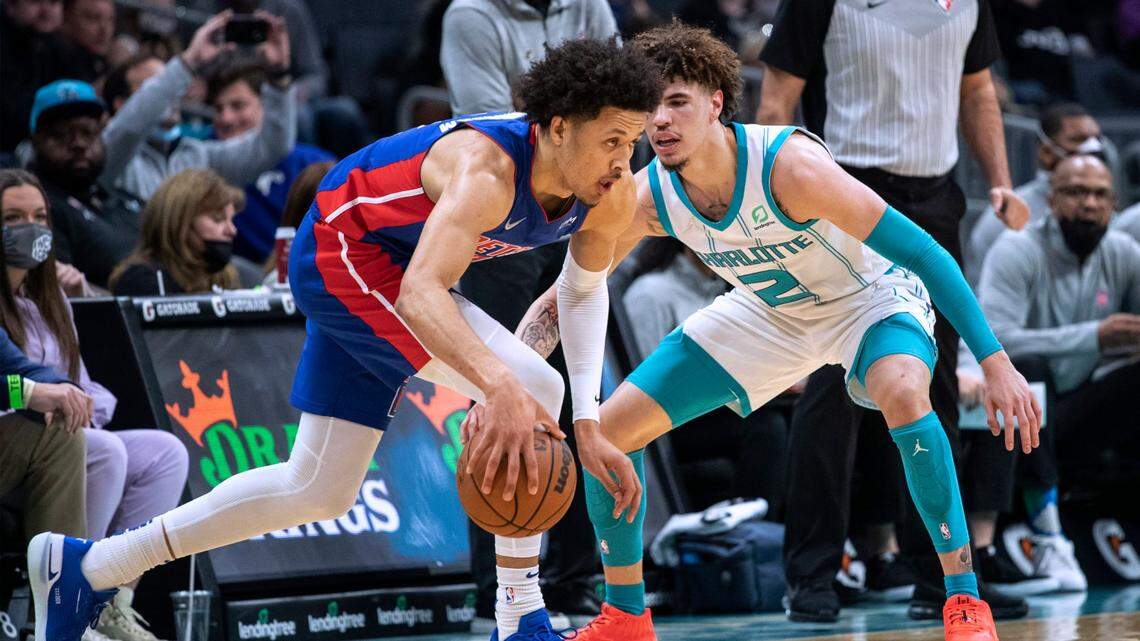 Charlotte Hornets guard LaMelo Ball, right, defends against Detroit Pistons guard Cade Cunningham during the first half of an NBA basketball game Wednesday, Jan. 5, 2022, in Charlotte, N.C. (AP Photo/Matt Kelley)