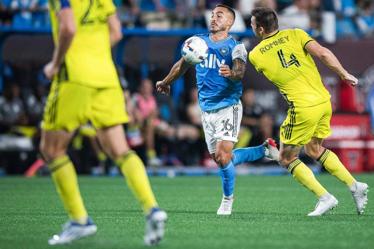 Charlotte FC forward Andre Shinyashiki (16) stops the ball with his chest and competes for control with Nashville SC defender Dave Romney (4) at Bank of America Stadium in Charlotte, N.C. on Saturday, July 9, 2022. Charlotte FC won the match 4 to 1.