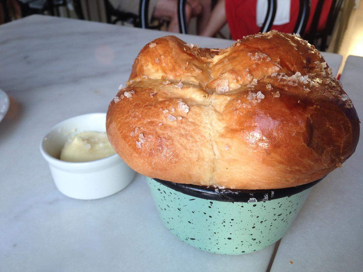 Kindred’s milk bread arrives warm and glistening with a little salt, ready to tear into.