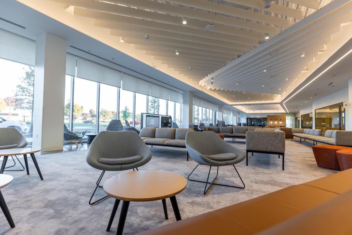 The open concept lobby tries to take away from the usual sense of a traditional waiting room. Instead, visitors sign up on a tablet with help from their Customer Experience Specialists at the Scarborough Community Resource Center in Charlotte on Wednesday, October 25, 2023.
