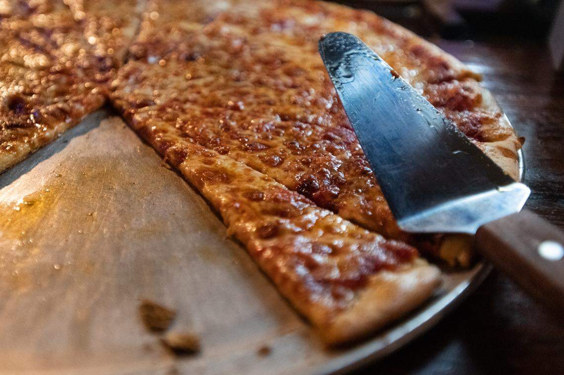 Pizza sits atop an indoor bar at Selwyn Avenue Pub in Charlotte, N.C. Tuesday evening, July 26, 2022.