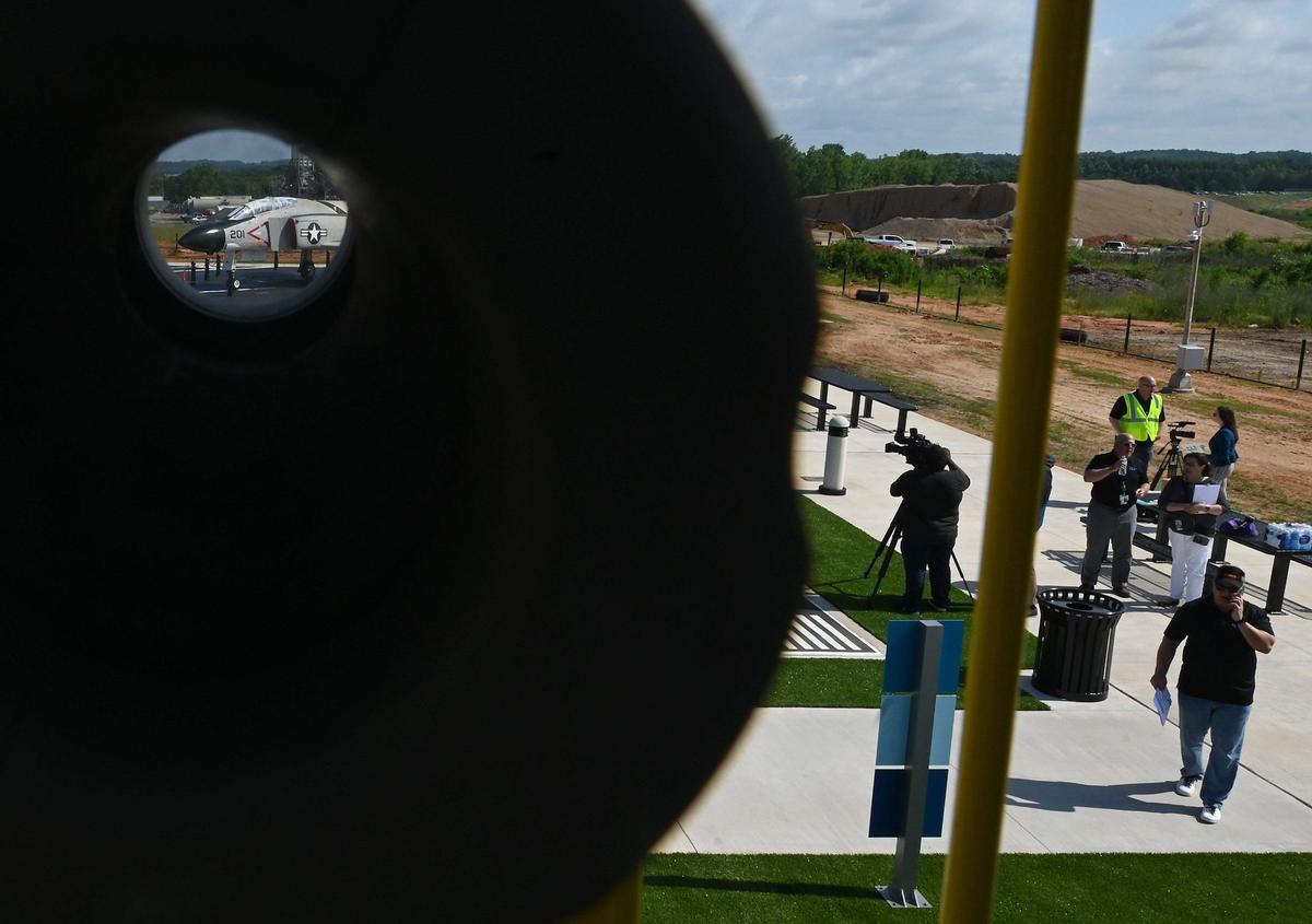 A telescope in the children’s playground area of the new Airport Overlook allows viewers to see an F4 Phantom II jet, left, along with other sites.