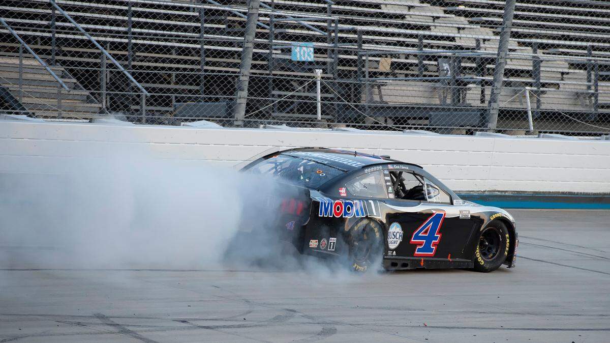 Kevin Harvick (4) does a burnout after winning a NASCAR Cup Series auto race at Dover International Speedway, Sunday, Aug. 23, 2020, in Dover, Del. (AP Photo/Jason Minto)