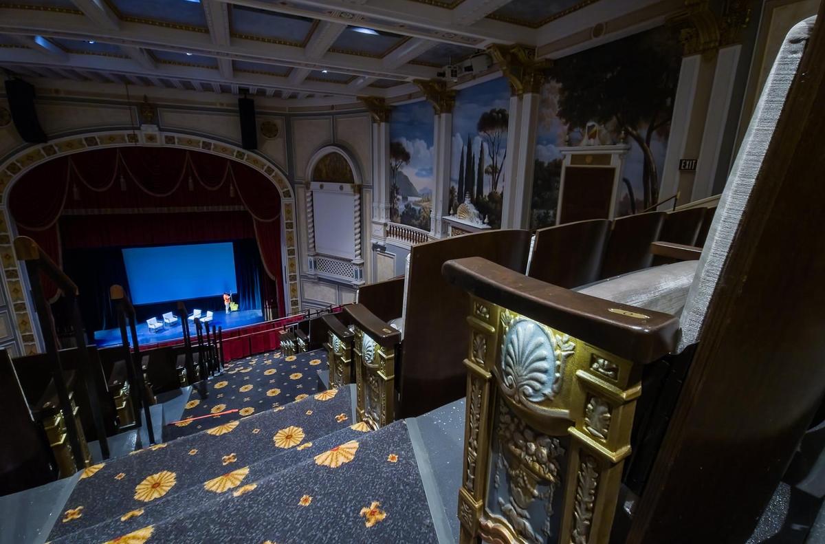 Rows of seats are flanked by an ornate gold design that also serves to light the walkway in the newly renovated and restored Carolina Theater a couple weeks before it reopened.