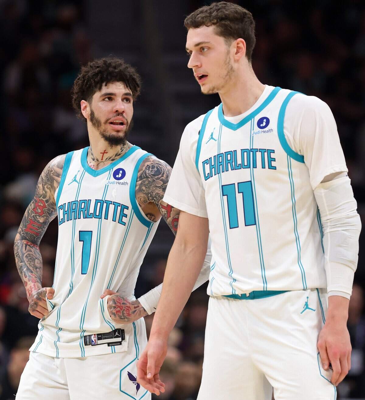 Charlotte Hornets guard LaMelo Ball, left, speaks with center Ryan Kalkbrenner during action against the Miami Heat at Spectrum Center in Charlotte, North Carolina, on April 14, 2026.