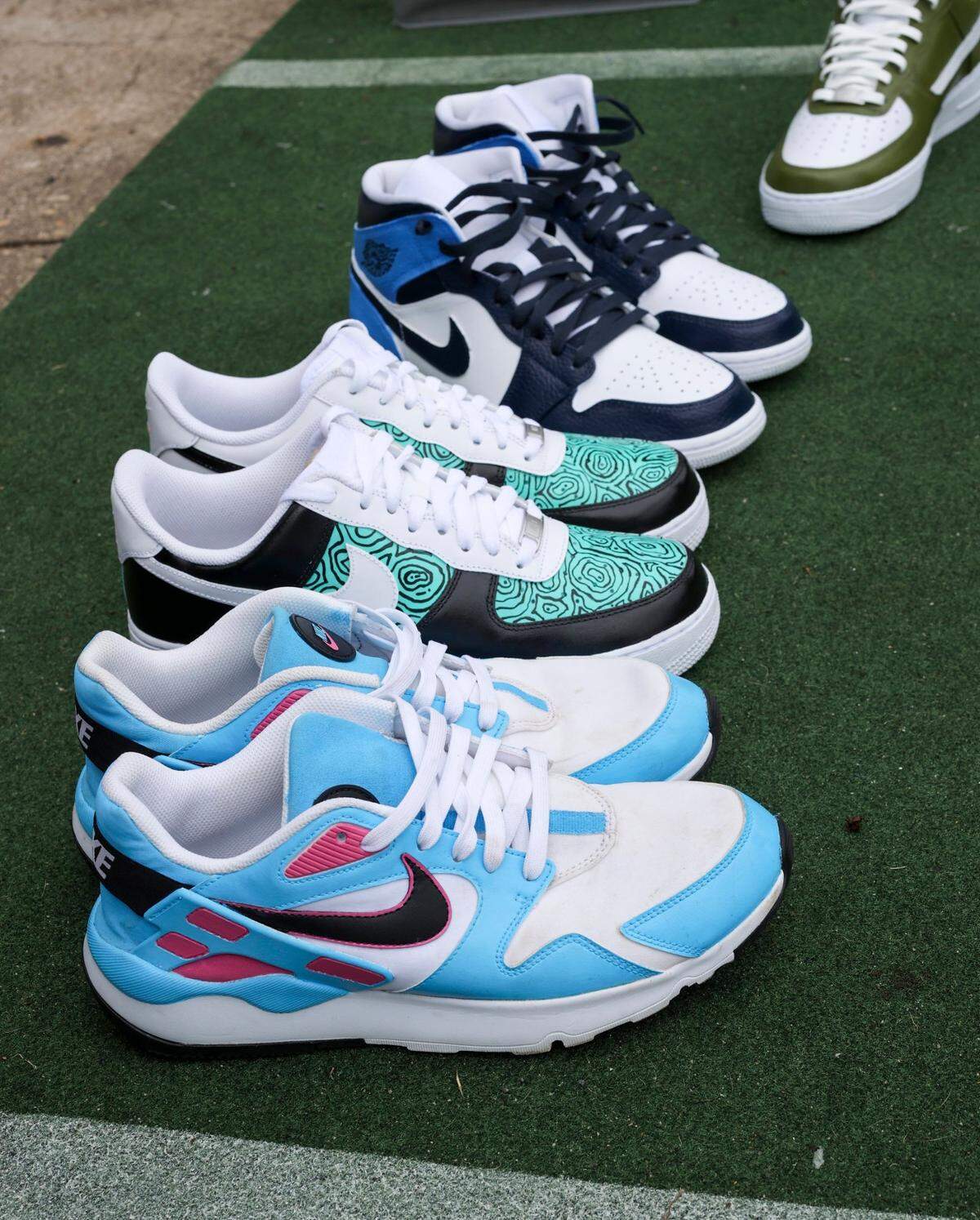 Samples of painted shoes by Jeremy Recoon, who creates custom Nikes for athletes and celebrities in Charlotte, N.C., Sunday, June 13, 2021.