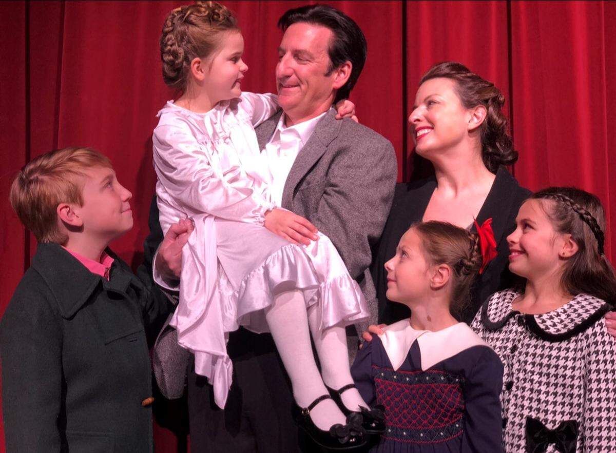 Matthews Playhouse of the Performing Arts presents “It’s a Wonderful Life,” Dec. 13-22 in Matthews. Pictured left to right are Sebastian Pawlik (Tommy Bailey ), Augusta Snyder (Zuzu Bailey), Geof Knight (George Bailey), Sophie Ryals (Susan Bailey), Amy Dunn (Mary Hatch), and  Victoria Mascia (Janie Bailey).