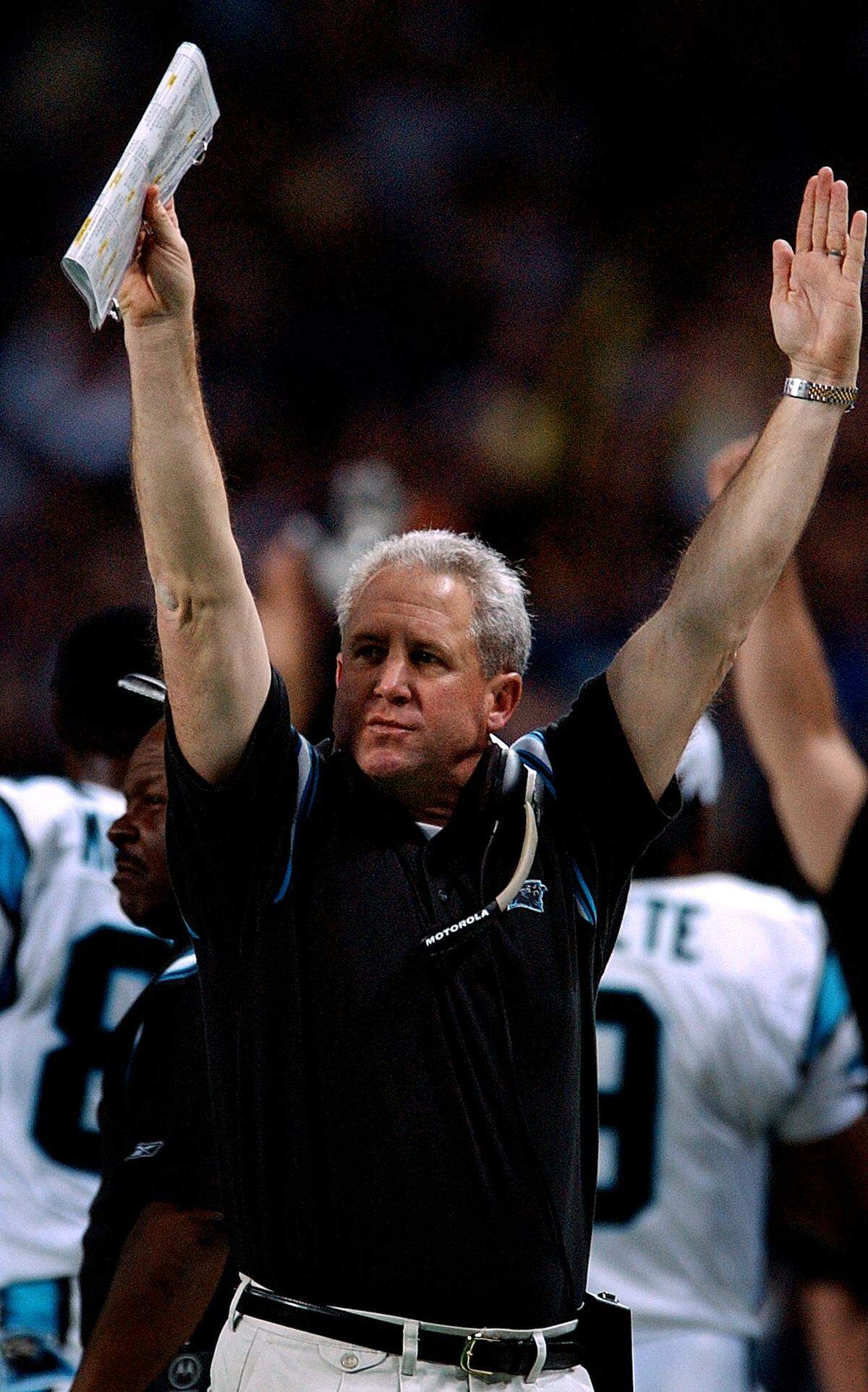 1/10/03 Carolina Panthers head coach John Fox signals a touchdown after Panthers receiver (87) Muhsin Muhammad fell on a loose ball in the end zone to score the team’s first touchdown vs the St. Louis Rams. The Panthers defeated the Rams 29-23 in overtime. JEFF SINER/STAFF