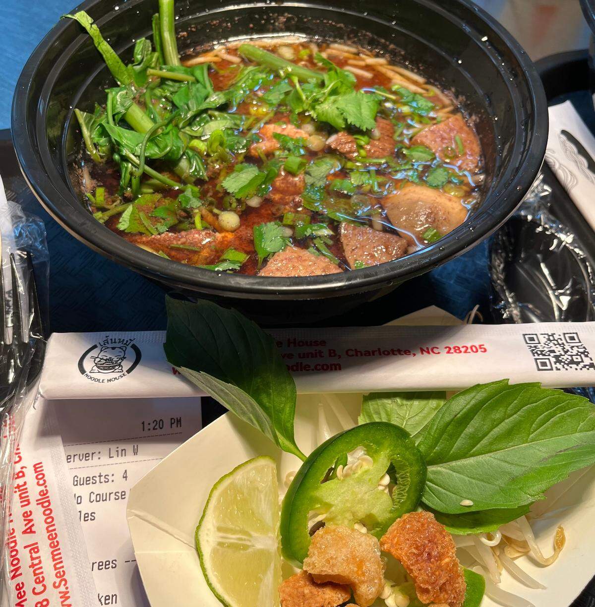 The Thai Boat Noodles at Sen Mee Noodle House is a rich, dark soy stew, served over rice noodles and paired with crispy pork rinds.