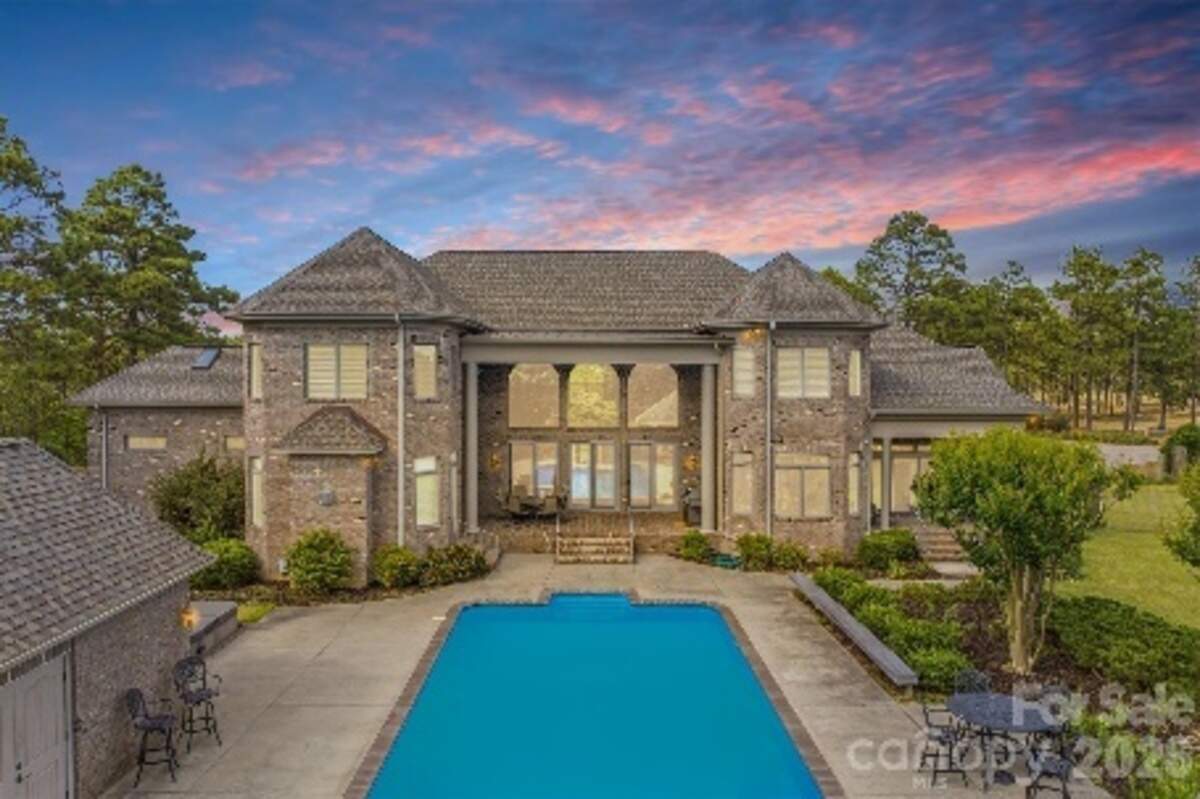 The mansion has a resort-style swimming pool with terraces and a pool house.