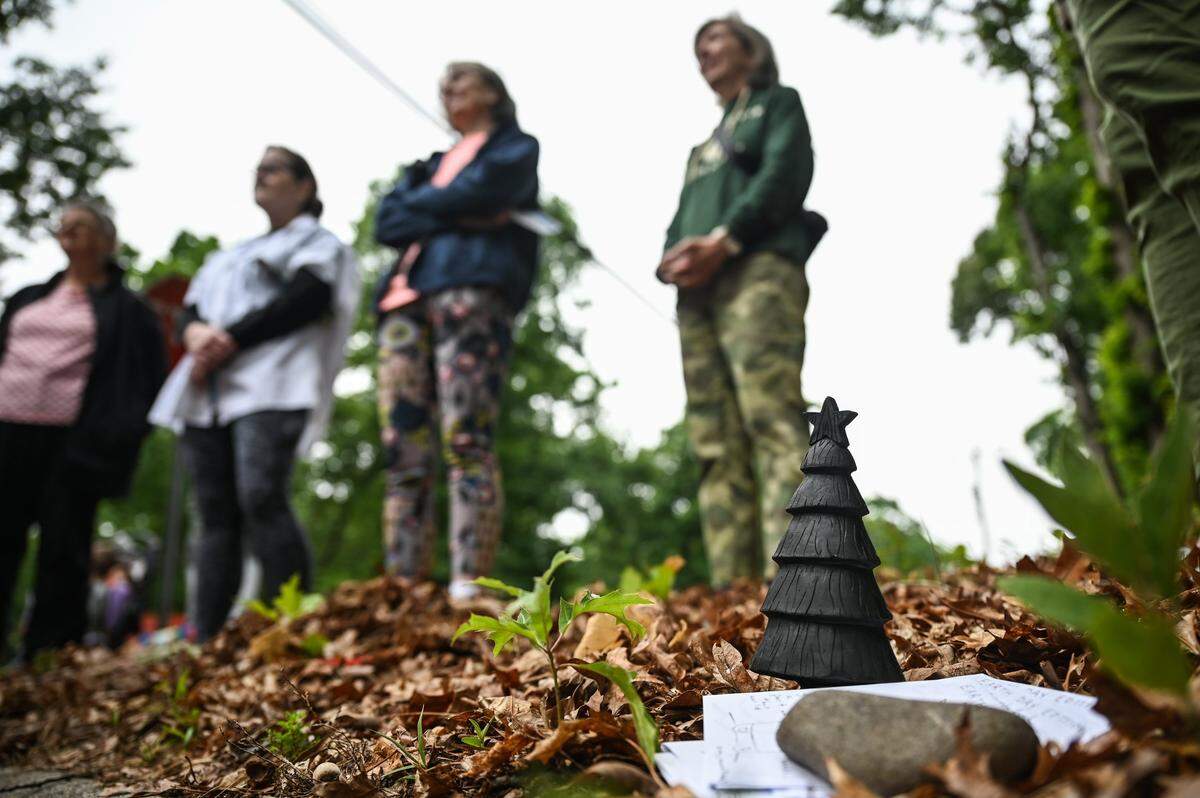 Residents of an east Charlotte neighborhood gather at the corner of Mayberry Lane and Wilora Lake Road, in front of a 6.6-acre wooded area the city approved a rezoning request for that will replace the trees with new housing, to hold a memorial service to mourn the eventual loss of the trees.