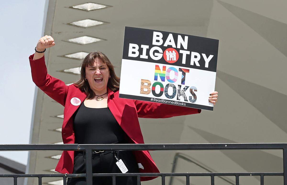 A woman cheers from above as teachers march back to the Government Complex in Raleigh, NC on Friday, May 1, 2026. The teachers gathered for a mass rally and to protest the need for more funding for public schools.