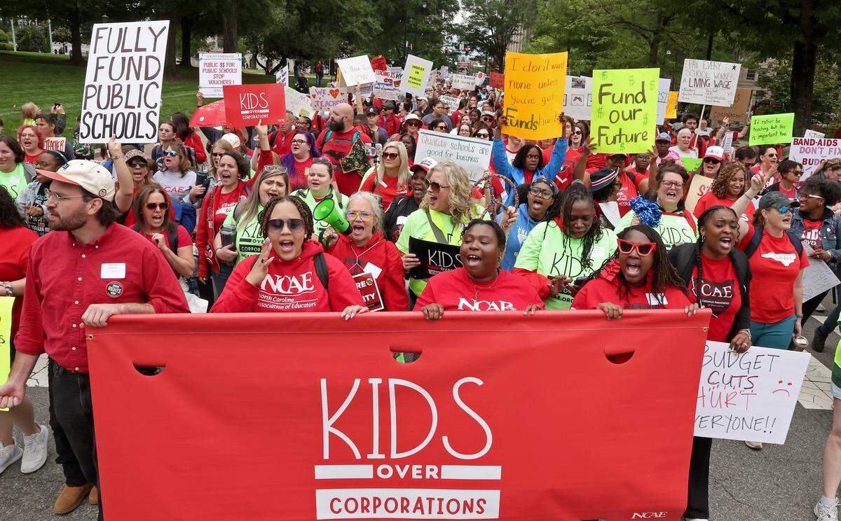Teachers march through downtown Raleigh, NC on Friday, May 1, 2026 during a mass rally to protest the need for more funding for public schools.