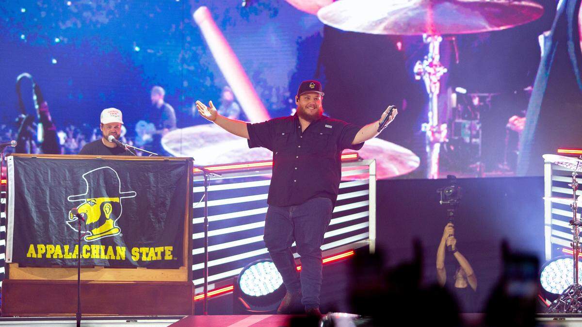 Luke Combs smiles as he takes the stage at Bank of America Stadium on Saturday, July 15, 2023. Combs played 2 nights in Charlotte to a packed stadium.