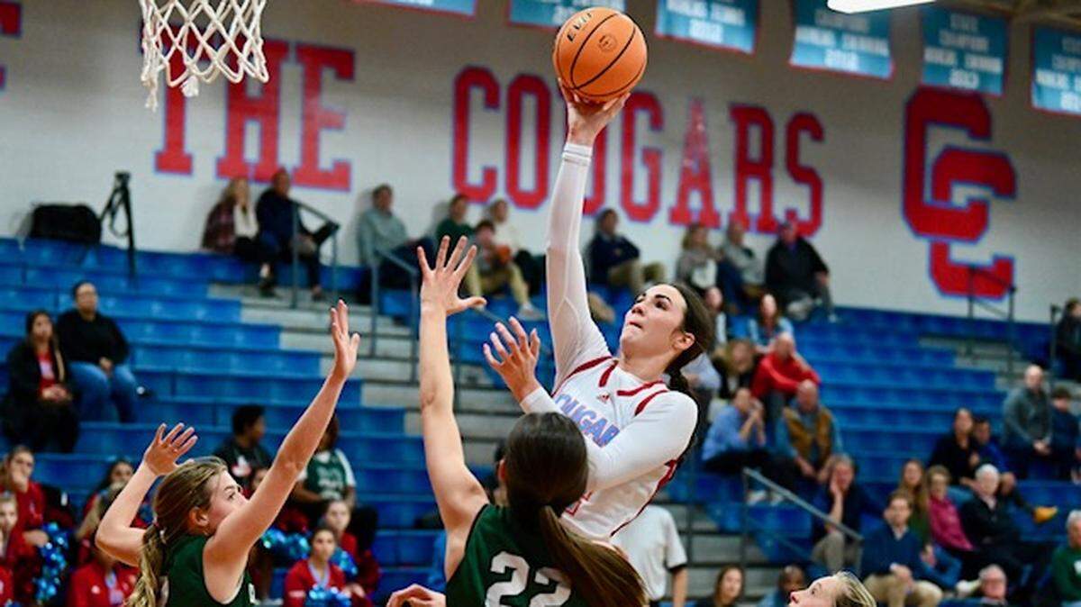 Charlotte Catholic’s Blanca Thomas, center, releases a shot in the lane over the Charlotte Country Day School defense during first half action on Tuesday, December 6, 2022 at Charlotte Catholic. Jeff Siner/The Charlotte Observer