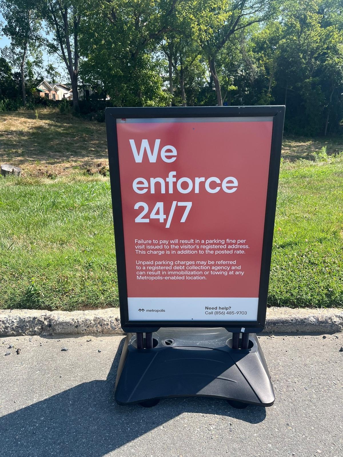 Signs at the Amtrak station on North Tryon Street give this warning. Paid parking has begun.