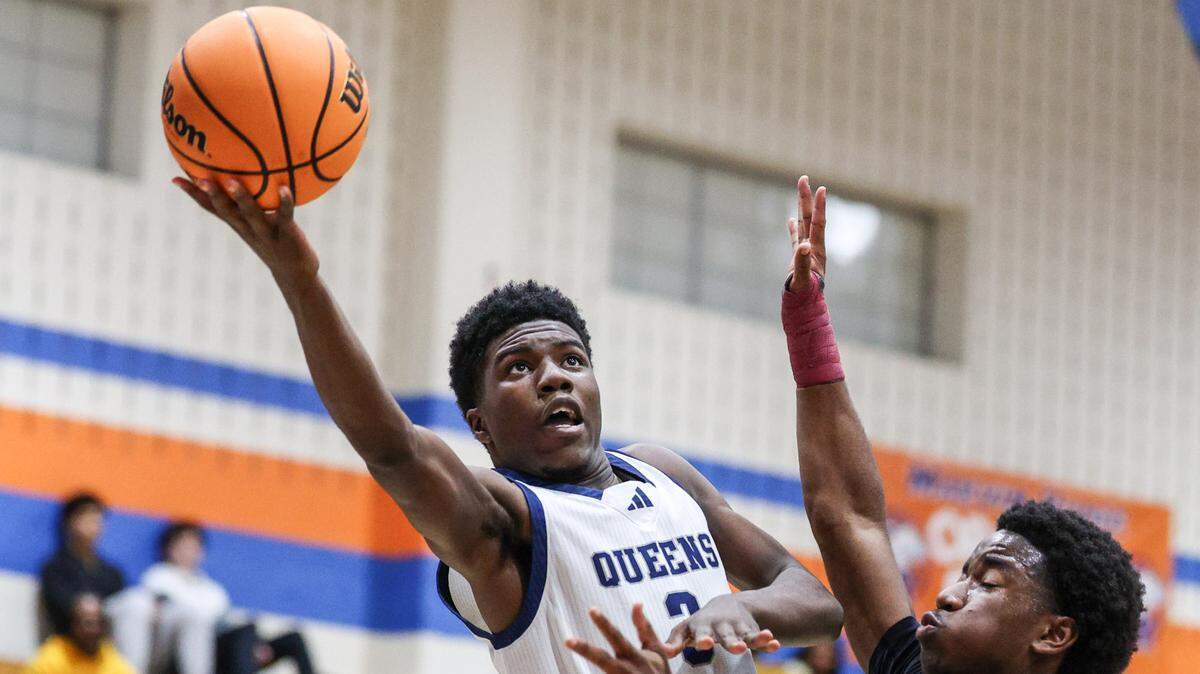 Queens Grant’s Preston Scott, center, extends for a shot over Victory Christian’s Justyn Whitfield during Phenom Hoops’ New Year’s Eve Bash championship game at Marvin Ridge High School on Monday, December 30, 2024.