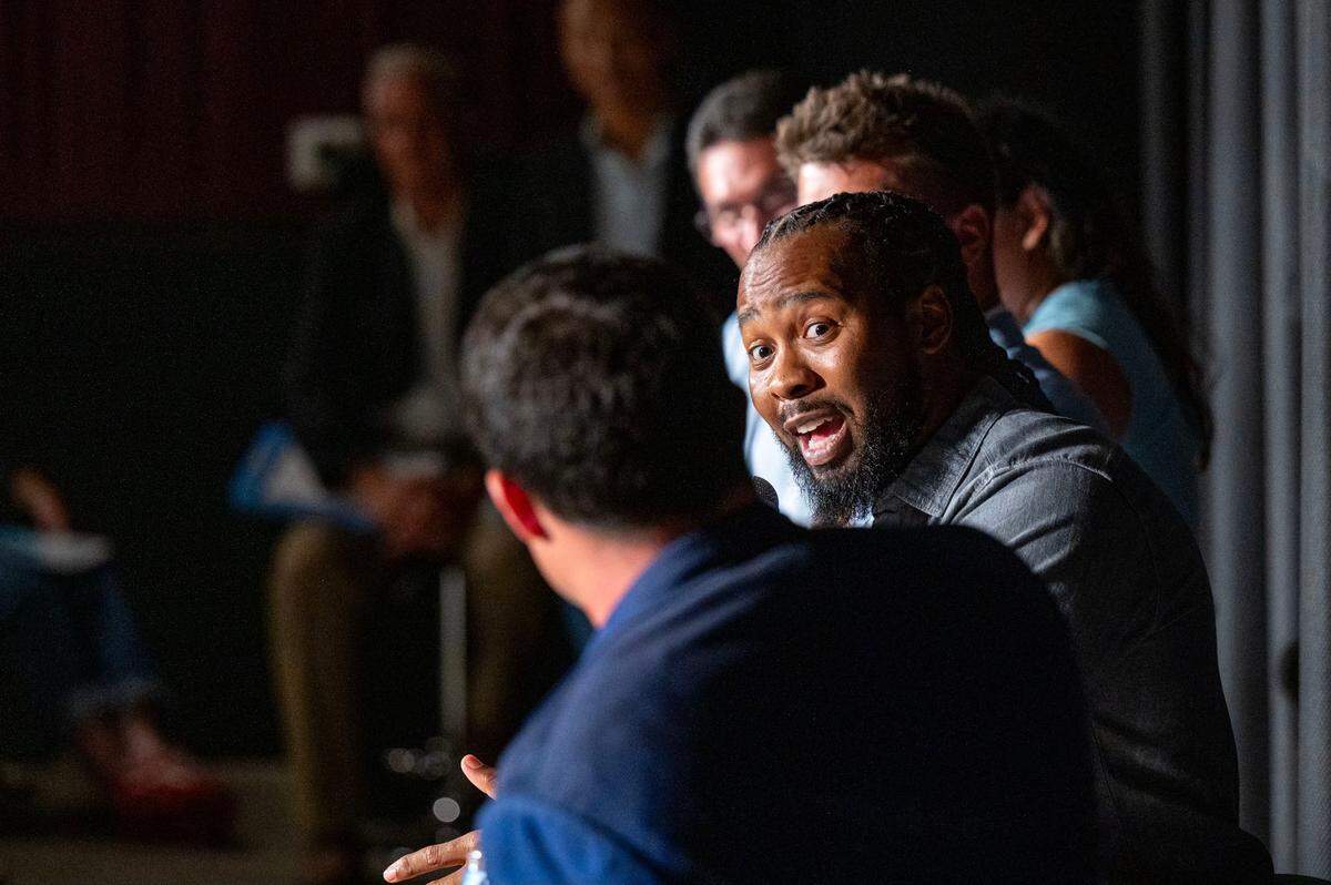 Former Carolina Panthers cornerback Josh Norman, second from left, talks with linebacker Luke Kuechly during the a panel discussion following the premiere of Super Men at the Independent Picture House in Charlotte, NC on Thursday, July 24, 2025.