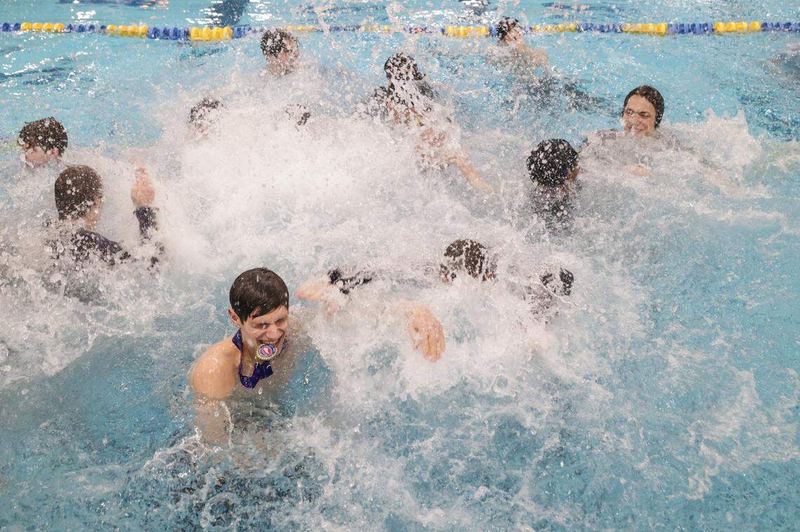 The Charlotte Latin boys team jump in the pool and splash around to celebrate their fourth consecutive title during the NCISSA state championships at Mecklenburg County Aquatic Center in Charlotte in 2024.