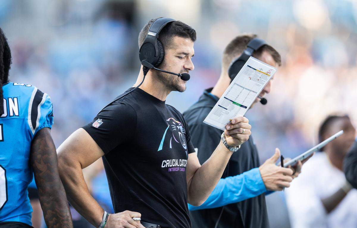 Carolina Panthers coach Dave Canales looks at his call sheet Sunday.