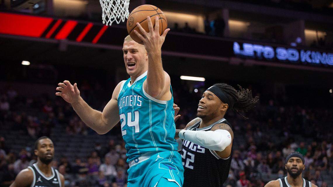 Charlotte Hornets center Mason Plumlee (24) and Sacramento Kings center Richaun Holmes (22) battle for the ball during the first quarter of an NBA basketball game in Sacramento, Calif., Friday, Nov. 5, 2021. (AP Photo/Randall Benton)