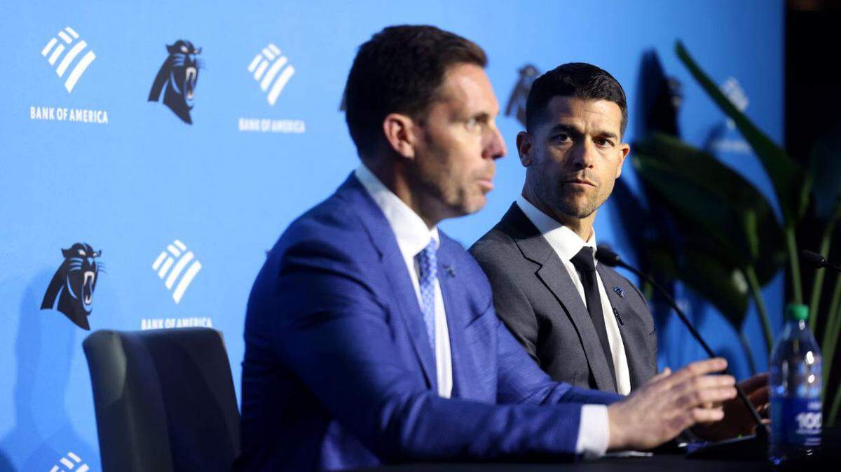 Panthers new head coach Dave Canales, right, listens to Panthers GM Dan Morgan during the introduction of the new coach Thursday morning, Feb. 01, 2024.