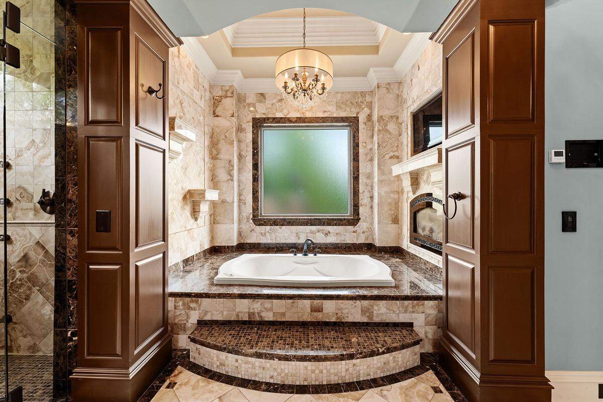 The primary suite of the mansion features an en-suite bathroom, a private sitting area and a balcony overlooking the grounds.