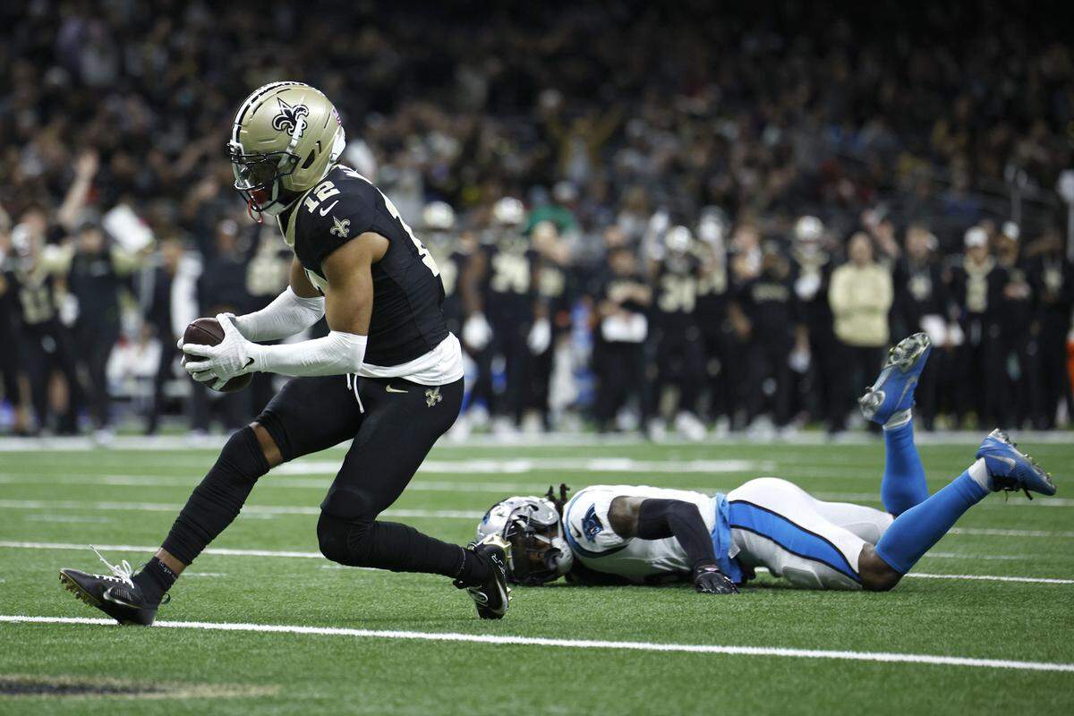 Chris Olave of the New Orleans Saints scores a touchdown against Jaycee Horn of the Carolina Panthers during Sunday’s fourth quarter at Caesars Superdome.