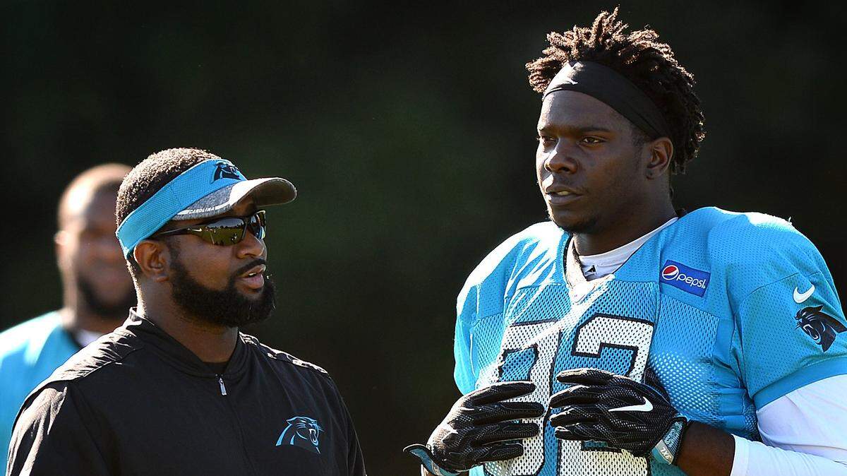 Carolina Panthers assistant defensive line coach Sam Mills III, left, talks with defensive tackle Vernon Butler, right, during practice in 2017.