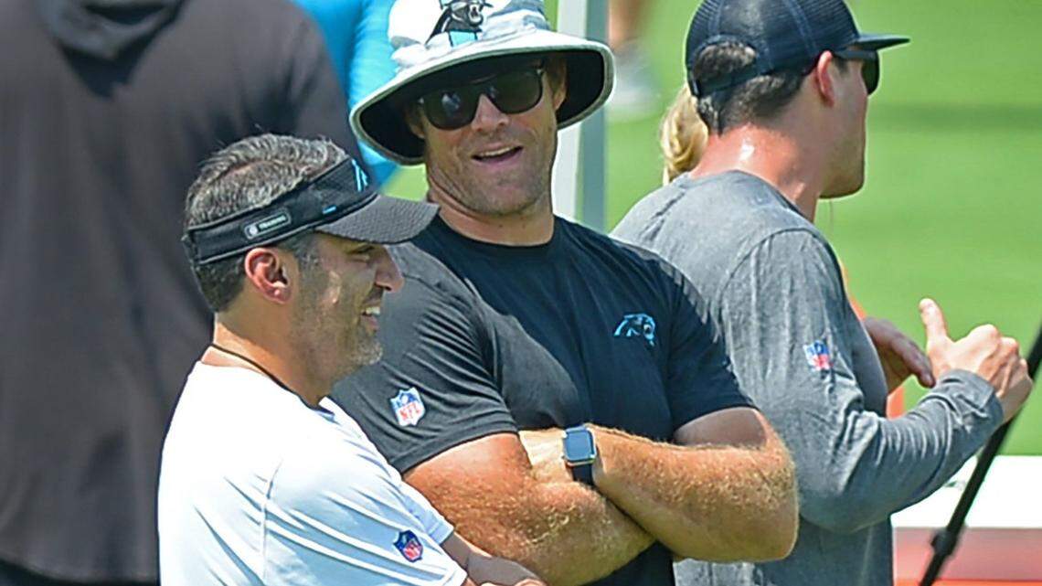 Carolina Panthers Director of Player Negotiations & Salary Cap Manager Samir Suleiman, left and former tight end Greg Olsen, right, talk during practice in August. Suleiman is responsible for figuring out how the Panthers can afford their roster and is on track to become an NFL general manager.