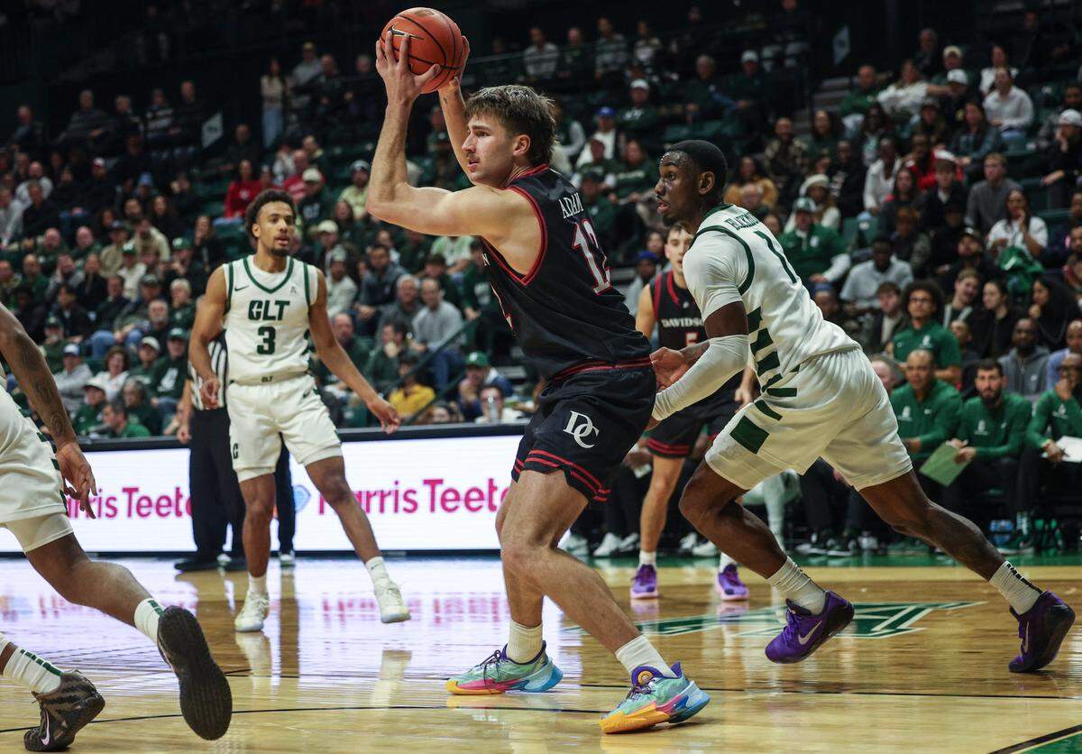 Davidson guard Hunter Adam, center, looks for a pass as Charlotte applies pressure during the final seconds of the game at Dale F. Halton Arena on Tuesday, November 11, 2025.