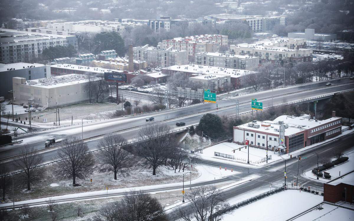 Rain and sleet that moved into the area overnight creates a thin wintry blanket over Uptown Charlotte on Sunday, January 25, 2026.