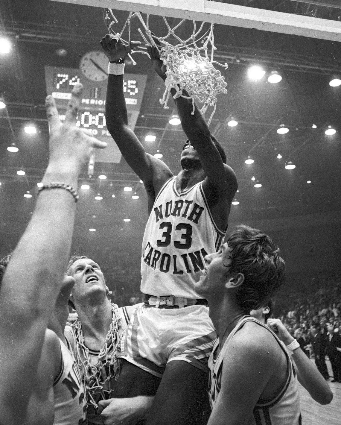 UNC’s Charlie Scott is lifted up by teammates to cut a strand of the net after the Tar Heels won the 1969 ACC Championship game in Charlotte, NC.