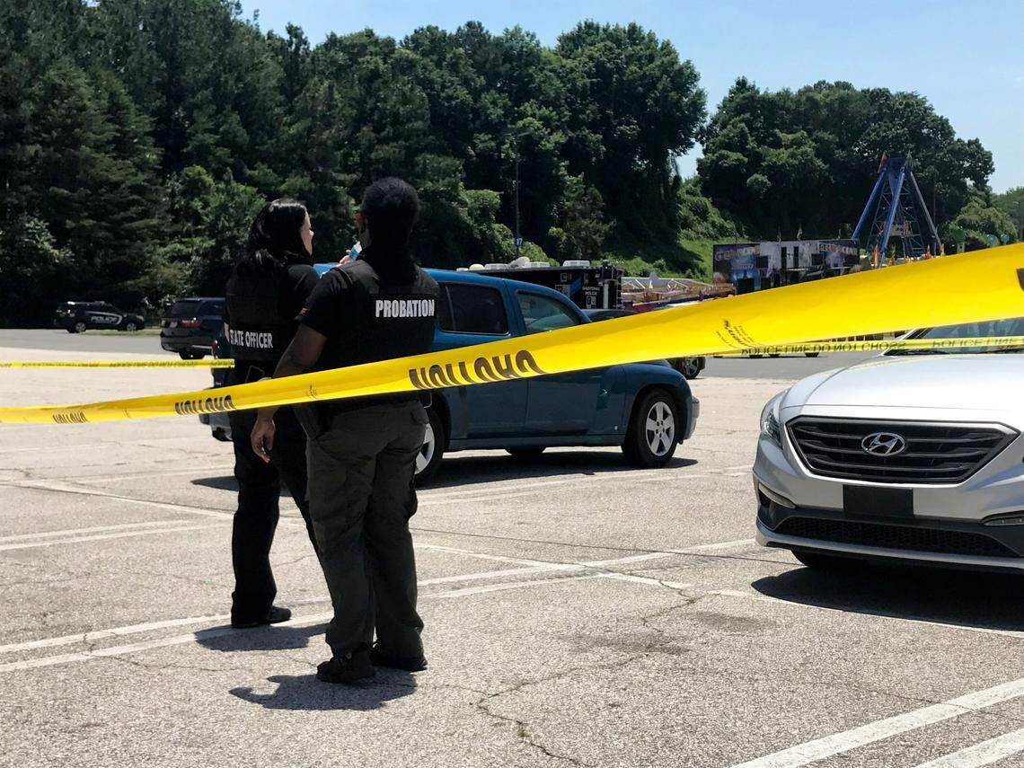Police survey the scene outside Eastridge Mall, where three people were injured during a shooting in the food court in Gastonia on Friday, June 10, 2022.