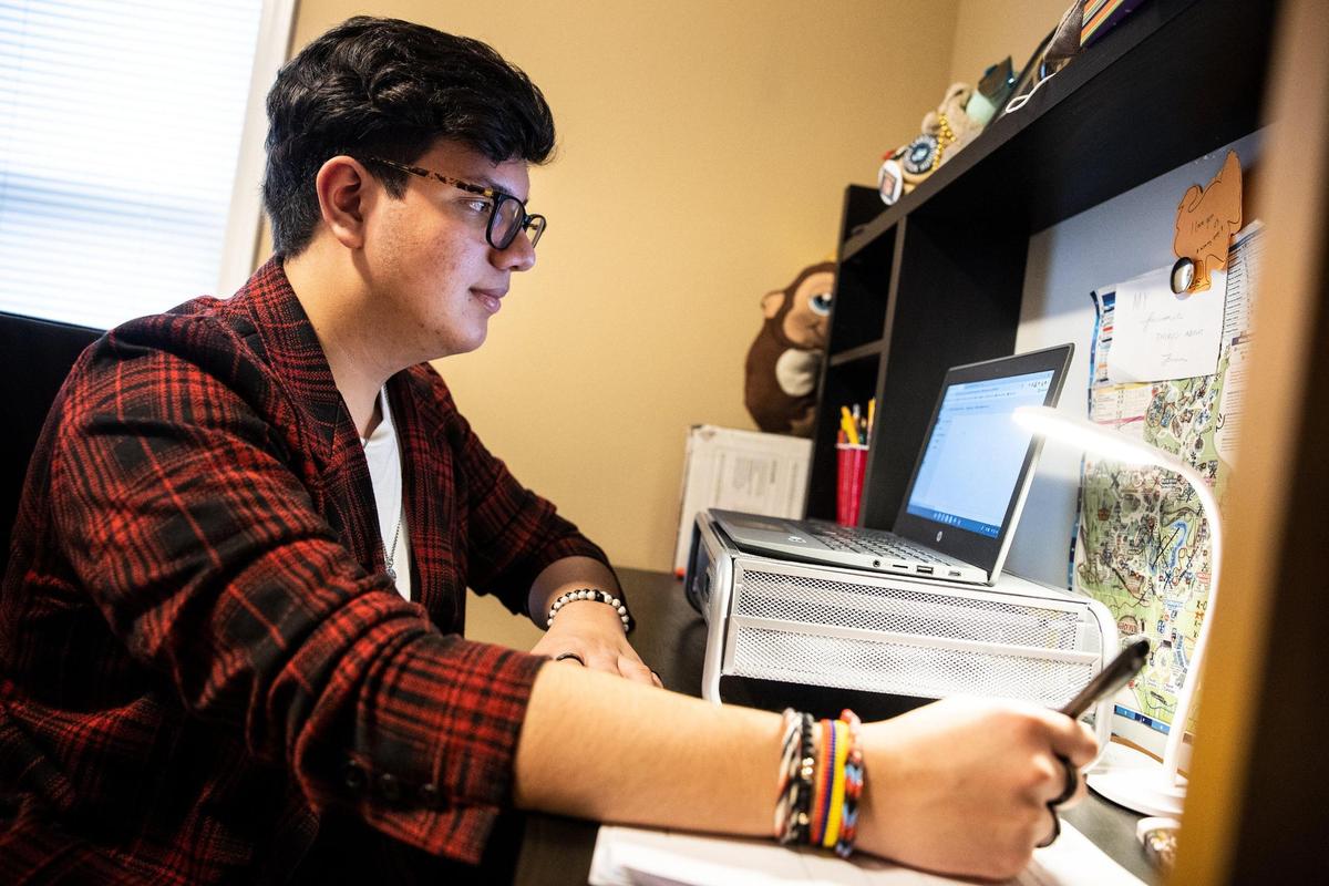 JuanTorres Muñoz does his homework at home in Charlotte on Jan. 20, 2022.